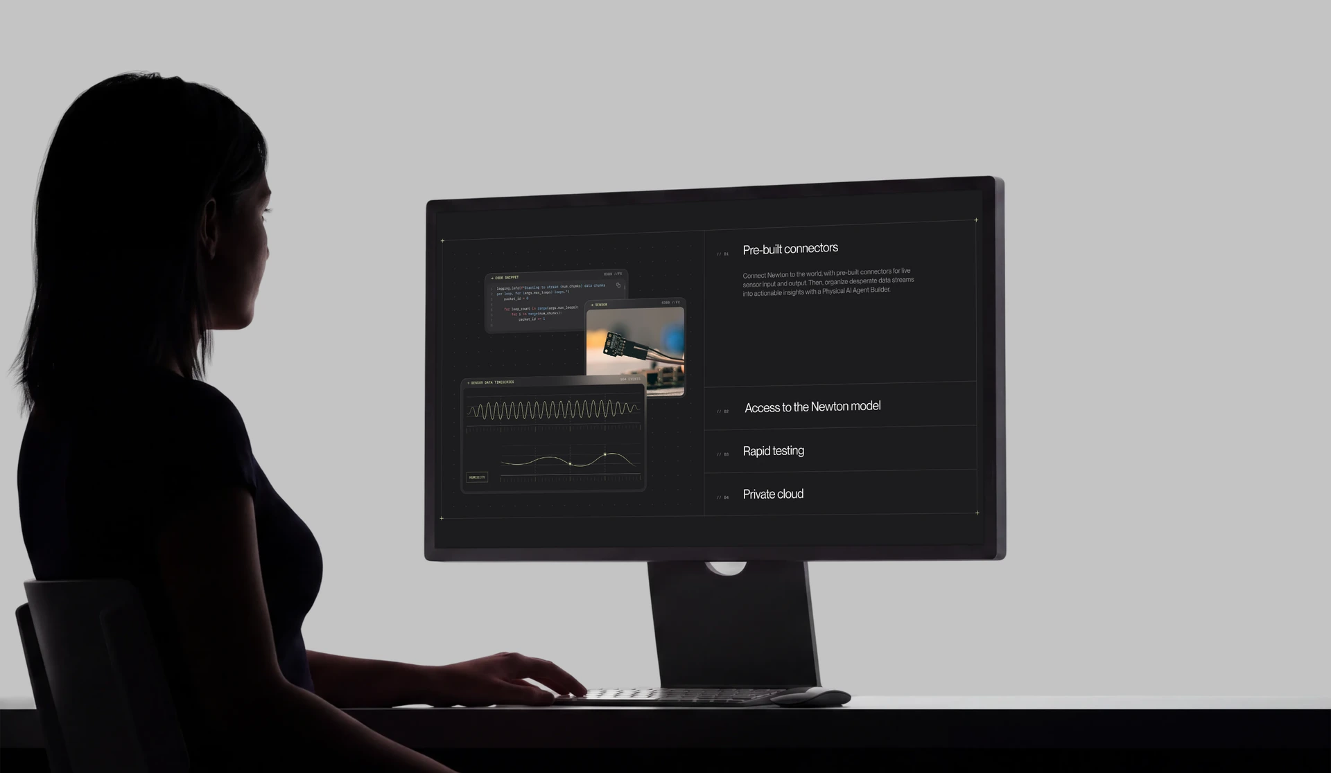 Newton dark-mode interface on a desktop monitor, person at the desk